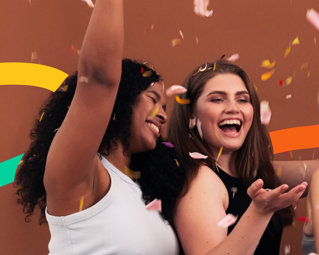 Young women celebrating together with confetti at a Brown Rice community event