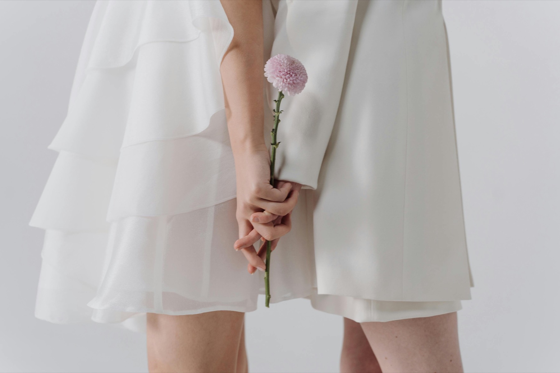 A young woman holding a flower as a symbol of one-to-one support