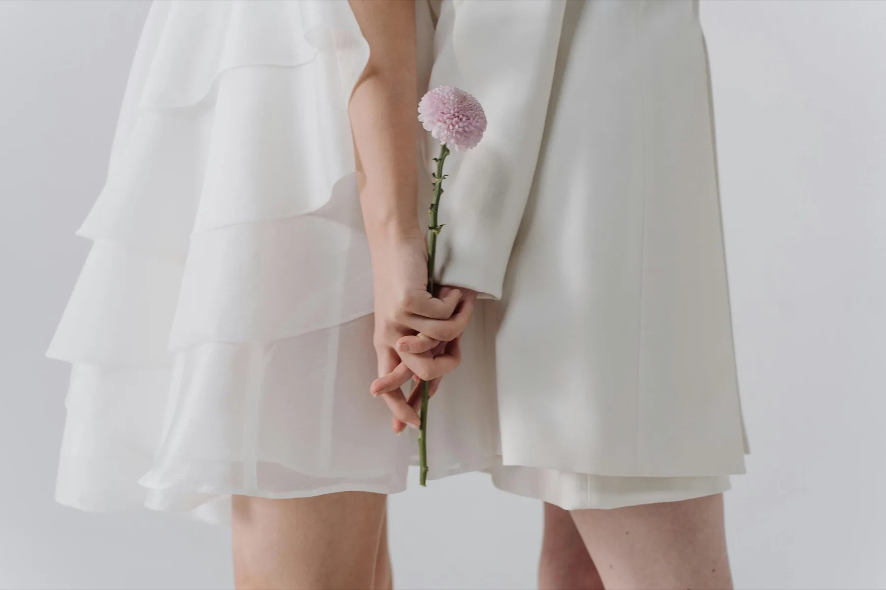 A girl holding a flower as a symbol of one-to-one support